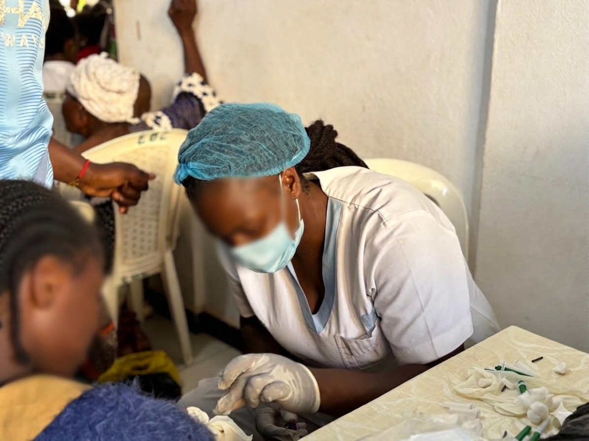 Healthcare worker with a young patient during a community blood-care visit